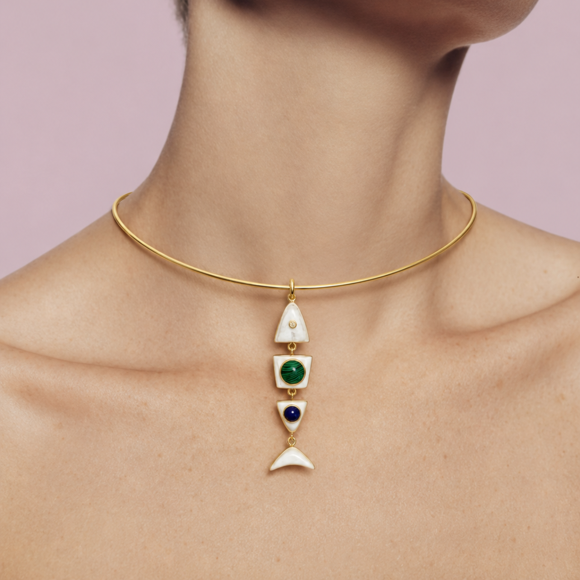MLO geometric pendant suspended from a minimal gold choker